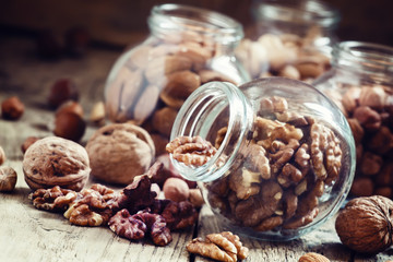 Walnuts in a glass jar, nut mix, toned image, selective focus