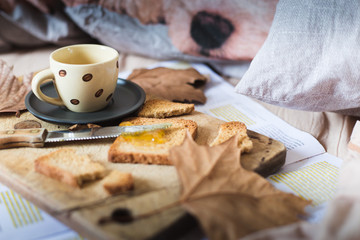 a representation of breakfast time on bed, with coffee espresso, rusks with marmelade, typical mediterranean breakfast