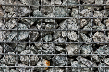 Stone paving stones of granite in a steel container