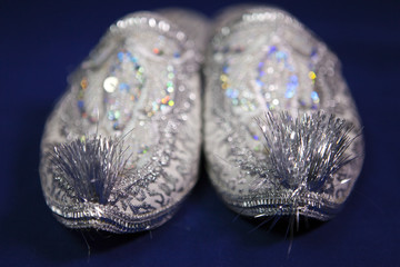 east style bride wedding shoes on a blue velvet,small depth of sharpness..