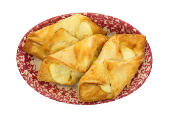 Cheese danish pastries on an old plate top view isolated on a white background.