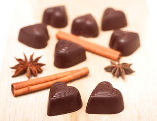 Chocolate candies shaped heart on a wooden background
