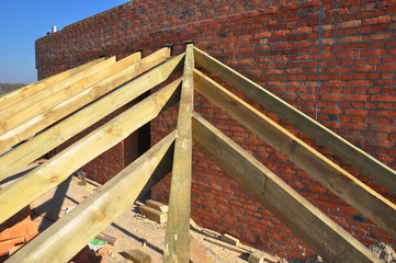 Roofing Construction. Close up on wooden rafters, eaves, wooden beams