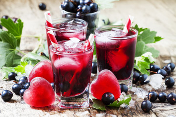 Berry cocktail with red hearts made of ice in the shape of heart