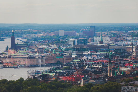 Beautiful super wide-angle panoramic aerial view of Stockholm, Sweden with harbor and skyline with scenery beyond the city, seen from the observation tower, sunny summer day with blue sky
