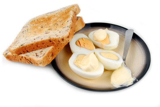 eggs and bread on plate isolated