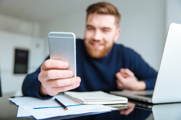 Man sitting at the table and using smartphone