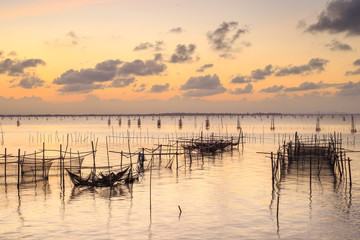 Fototapeta premium Twilight The bamboo coop for feeding fish. in south of Thailand sea. Songkhla, Koh-Yor