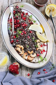 Quinoa salad with pomegranate and roasted nuts .Healthy eating. Superfoods concept