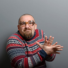 Portrait of a nerd clapping hands with glasses and retro sweater