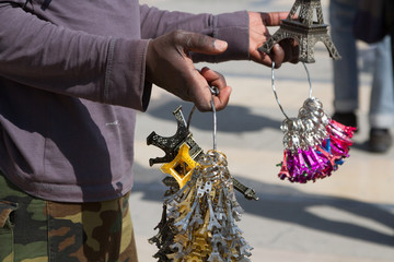 African immigrant offering souvenirs front of the Palace in Versailles