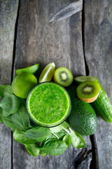 fresh green smoothie on wooden surface