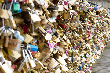 Padlocks known as love locks adorn the Pont des Arts bridge that spans the Seine River in Paris, France