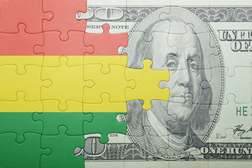 Fototapeta na wymiar puzzle with the national flag of bolivia and dollar banknote