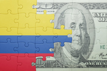 Fototapeta na wymiar puzzle with the national flag of colombia and dollar banknote