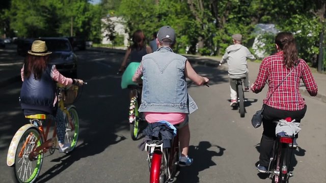 Back side of cycling group of people in summer day. Slow motion.
