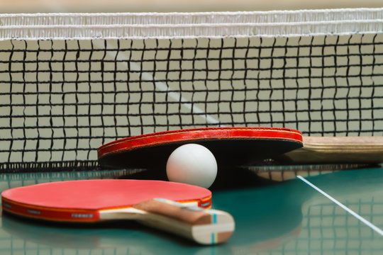 Tennis racket with a ball on the table