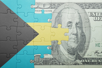 puzzle with the national flag of bahamas and dollar banknote
