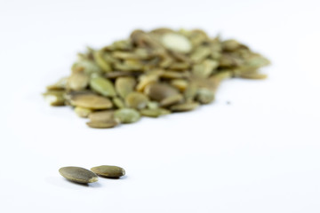 Closeup View of Pumpkin Seeds on a Plain Background