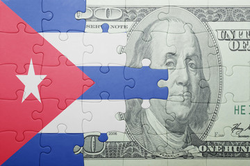 puzzle with the national flag of cuba and dollar banknote