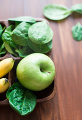 Fresh and organic green apple with spinach, bananas on rustic background. Healthy Still life