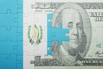 puzzle with the national flag of guatemala and dollar banknote