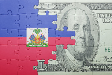puzzle with the national flag of haiti and dollar banknote