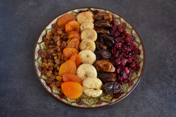 Dried fruit in a bowl on a dark background