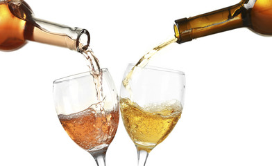 White and red wine pouring in glasses, isolated on white