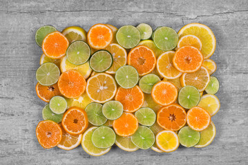 rectangle cut out citrus fruits on grey wooden background/ rectangle cut out citrus fruits on grey wooden background