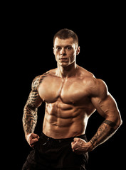 Fototapeta premium bodybuilder posing. Handsome power athletic guy male. Fitness mu