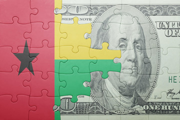 puzzle with the national flag of guinea bissau and dollar banknote