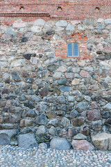 Glass window in old castle wall