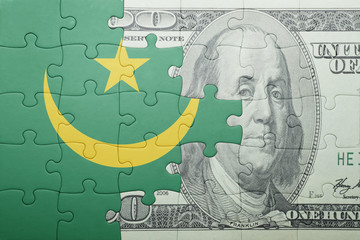 puzzle with the national flag of mauritania and dollar banknote
