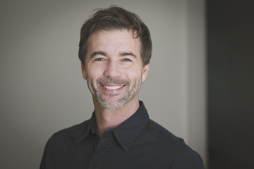 Fototapeta premium Portrait of a mature man smiling at the camera