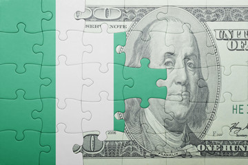 puzzle with the national flag of nigeria and dollar banknote