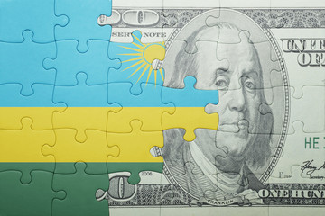 puzzle with the national flag of rwanda and dollar banknote