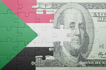 puzzle with the national flag of sudan and dollar banknote
