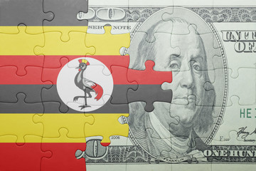 puzzle with the national flag of uganda and dollar banknote