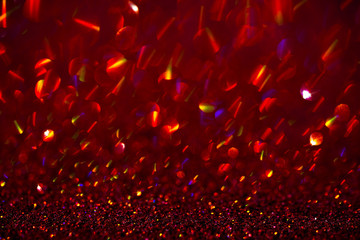 Red glitter abstract background with bokeh defocused. Macro shot. Shallow DOF.