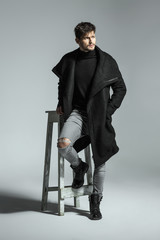 Handsome model in black long coat
