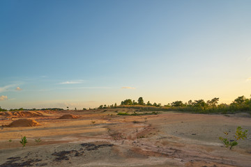 Tropical laterite soil or red earth background. Red mars seamless sand background.with blue sky.