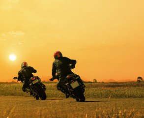 couples friend motorcycle rider biking on asphalt highway agains