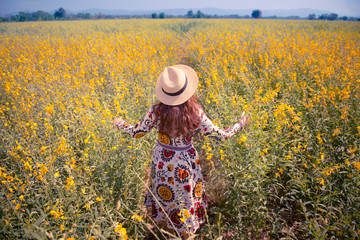 Woman is traveling into flower field