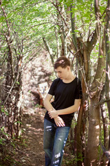the teenager costs on a footpath in the wood