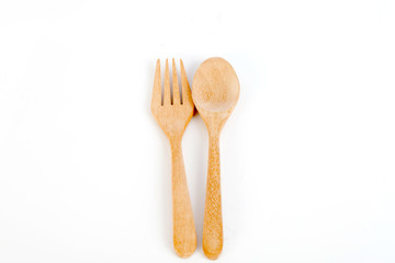 brown wooden spoons and forks on white background,selective focus