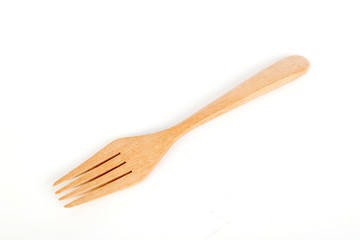 brown wooden forks on white background,selective focus