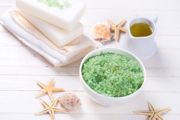 Spa setting with soap, towels, sea salt and aroma oil on  painte