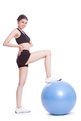 Fototapeta na wymiar Young woman doing exercises with fitness ball 