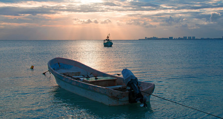 Sunrise View of anchored Mexican Fishing Boats in Puerto Juarez Harbor of Cancun Bay in Mexico